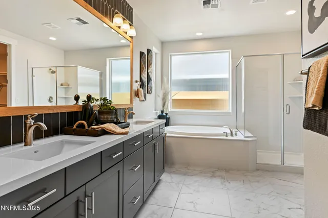 a bathroom with a tub sink and mirror