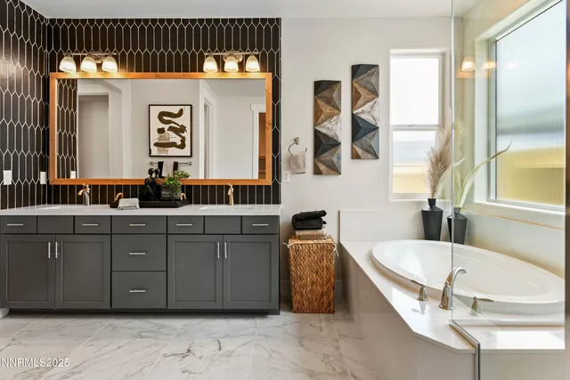 a bathroom with a tub sink and mirror
