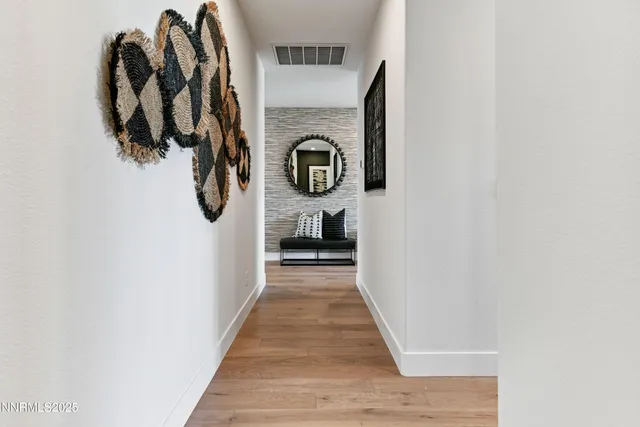 a hallway with front door wooden floor and windows