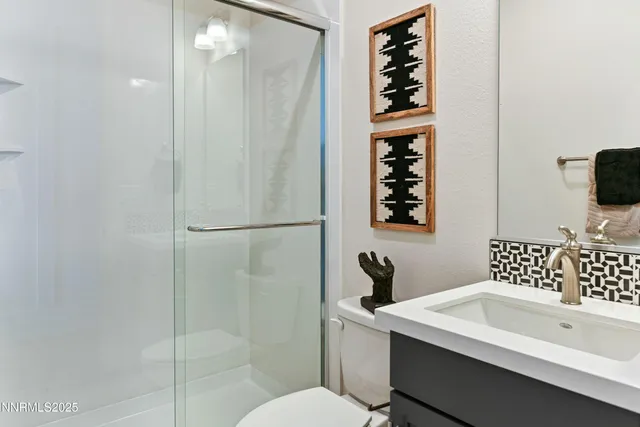 a bathroom with a sink toilet and shower