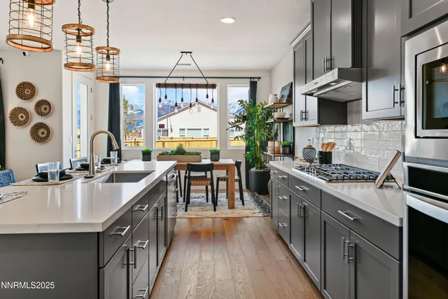 a kitchen with stainless steel appliances a sink stove and cabinets