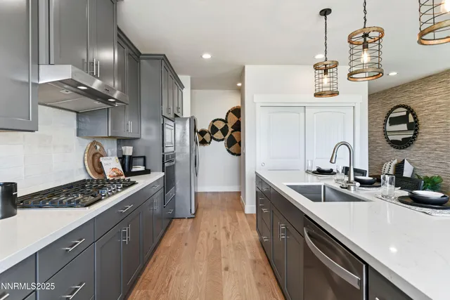 a kitchen with a sink stainless steel appliances and cabinets