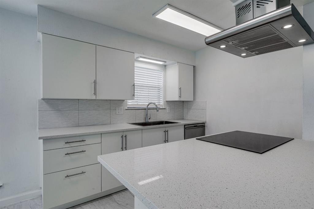 4606 Chaha Road, Unit 106 Garland, TX 75043 - Photo 12 of 22 Kitchen with sink, dishwasher, white cabinetry, island exhaust hood, and decorative backsplash