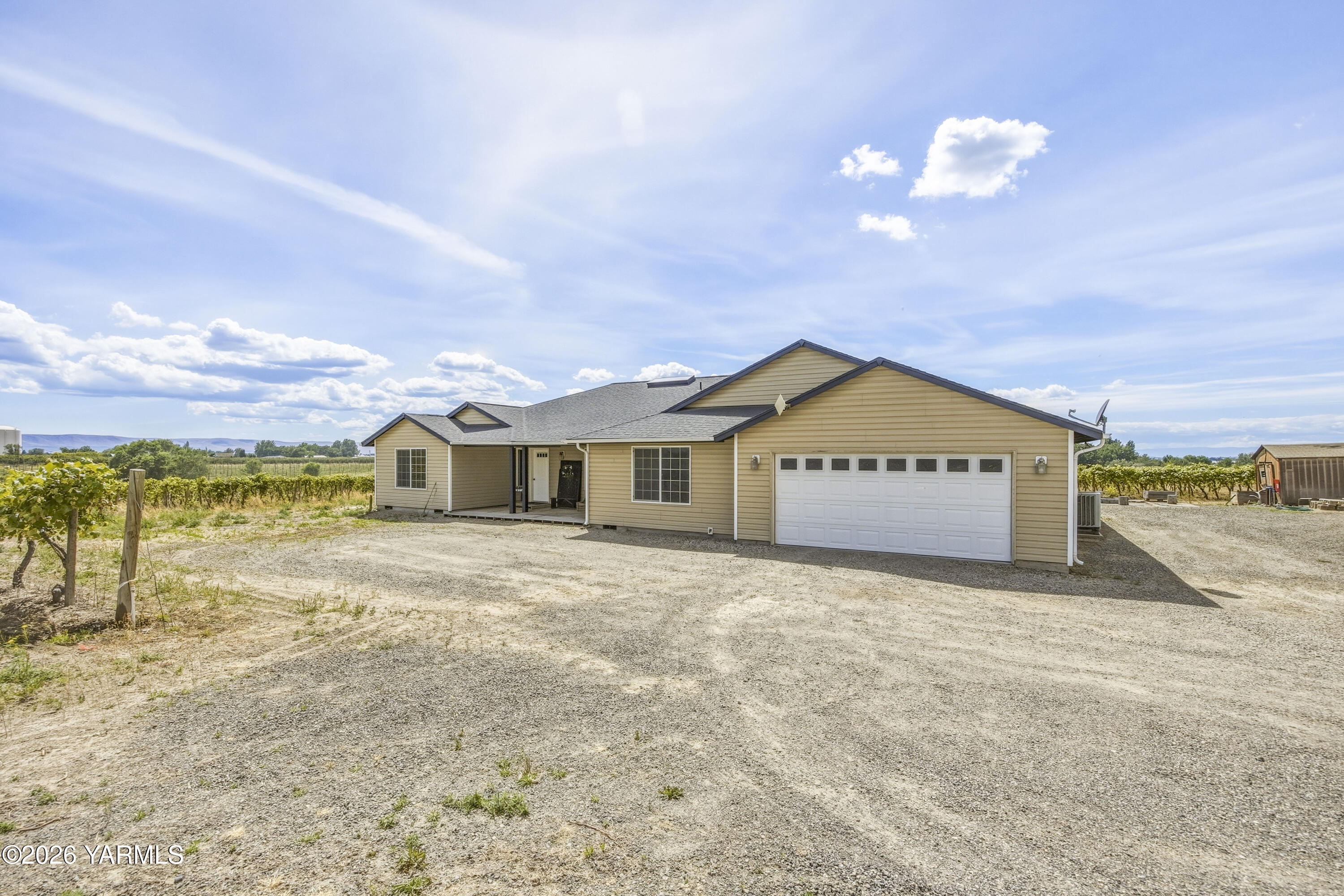 2050 Olmstead Road Grandview, WA 98930 - Photo 51 of 60 a view of a house with a yard and a large tree