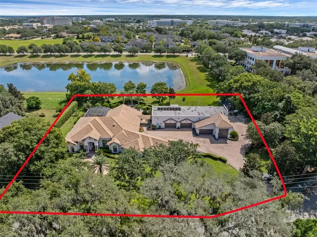 an aerial view of house swimming pool and lake view