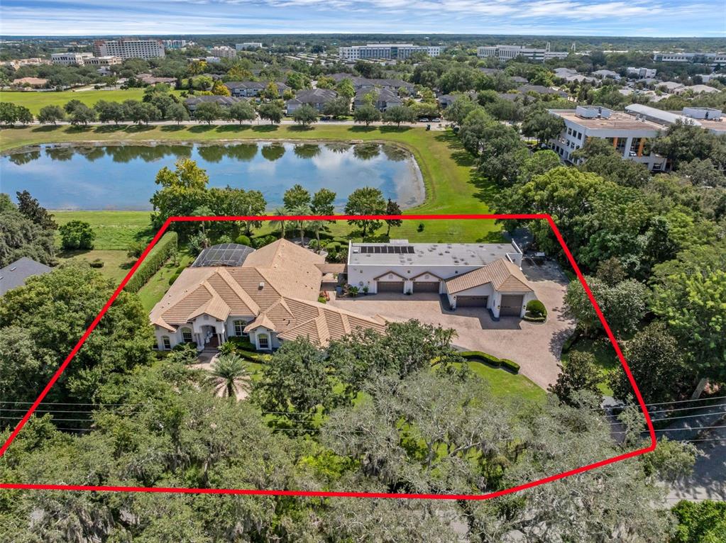 an aerial view of house swimming pool and lake view