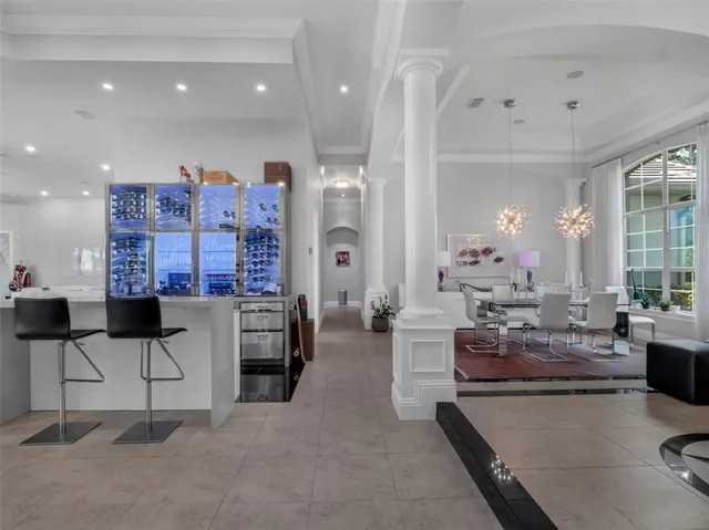 a large kitchen with kitchen island a sink and a refrigerator