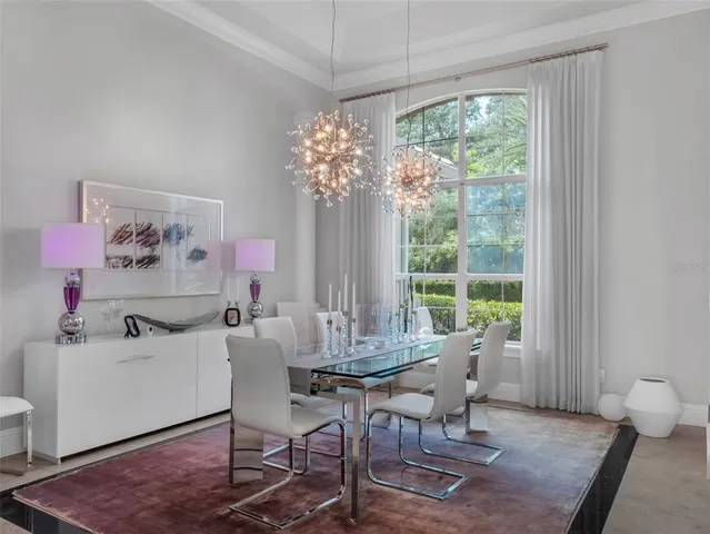 a living room with furniture and a view of kitchen