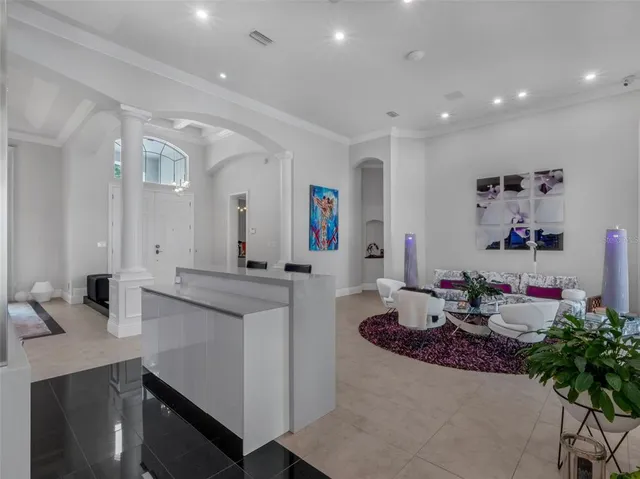 a large white kitchen with stainless steel appliances granite countertop a sink and cabinets