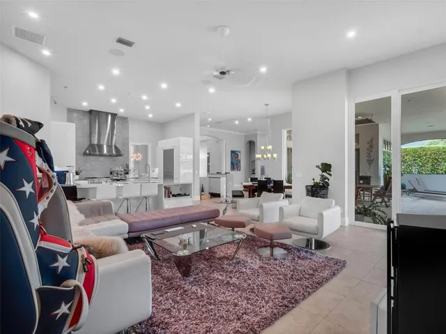 a living room with furniture and a book shelf