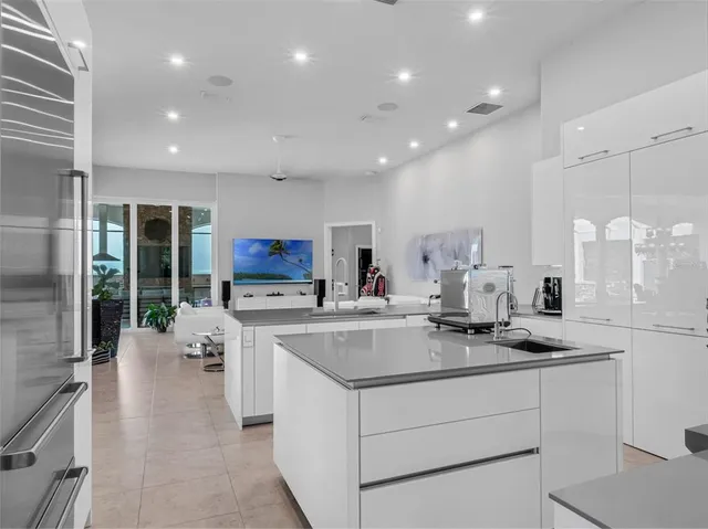 a large kitchen with a large counter top and stainless steel appliances