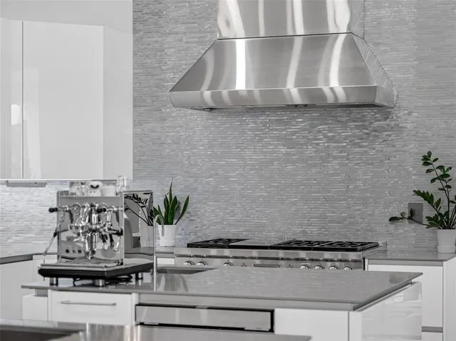 a kitchen with stainless steel appliances granite countertop a sink and a cabinets