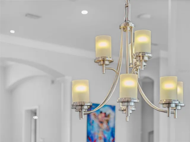 a bedroom with a bed a window and a flat screen tv