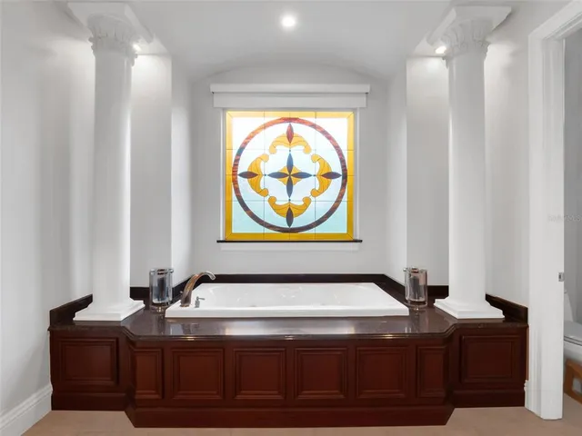 a living room with patio furniture and a large window