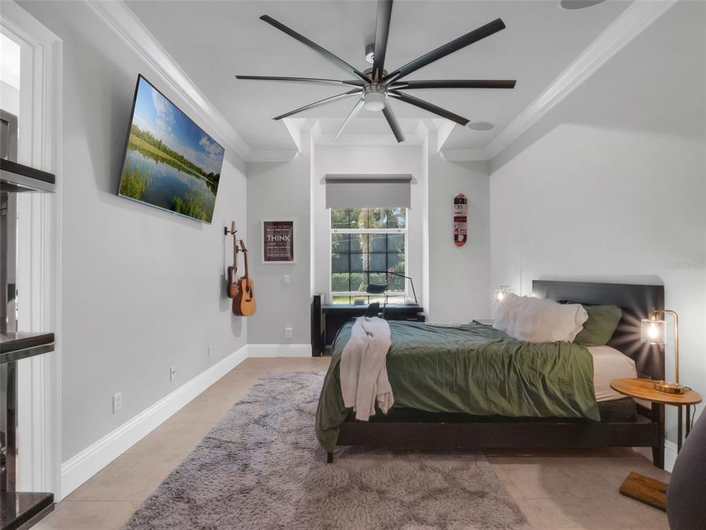 919 Banana Lake Road Lake Mary, FL 32746 - Photo 34 of 76 a bedroom with a bed a window and a flat screen tv