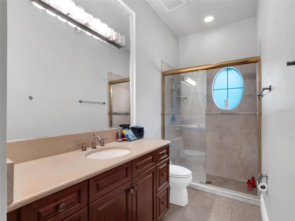 919 Banana Lake Road Lake Mary, FL 32746 - Photo 35 of 76 a bathroom with a toilet a sink and mirror