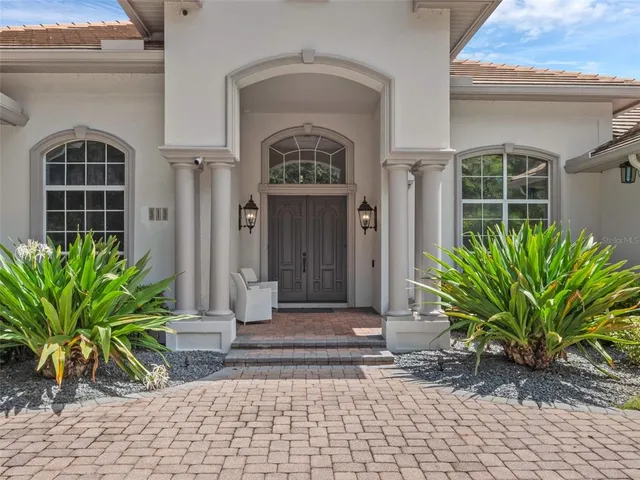 a front view of a house with potted plants