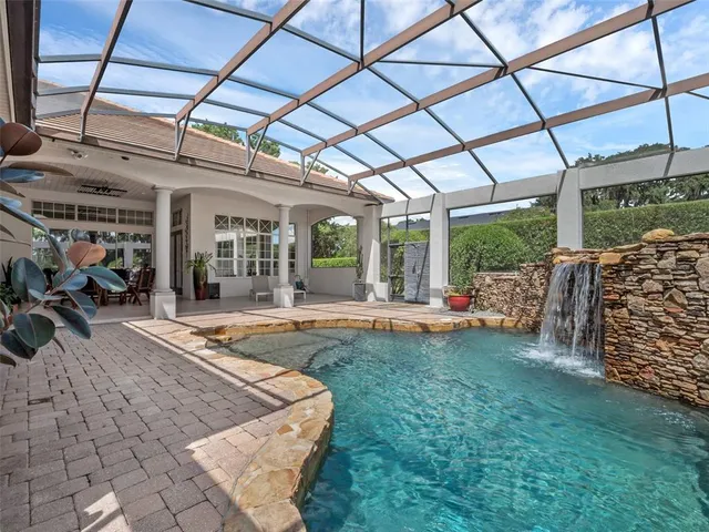 an aerial view of residential houses with outdoor space and river