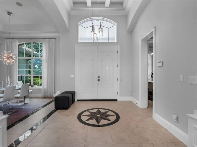 a view of a dining room with furniture a chandelier and wooden floor