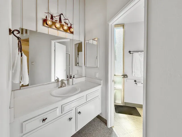 a bathroom with a sink and a mirror