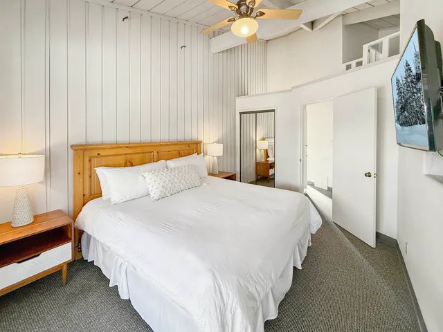 a bedroom with bed and a chandelier