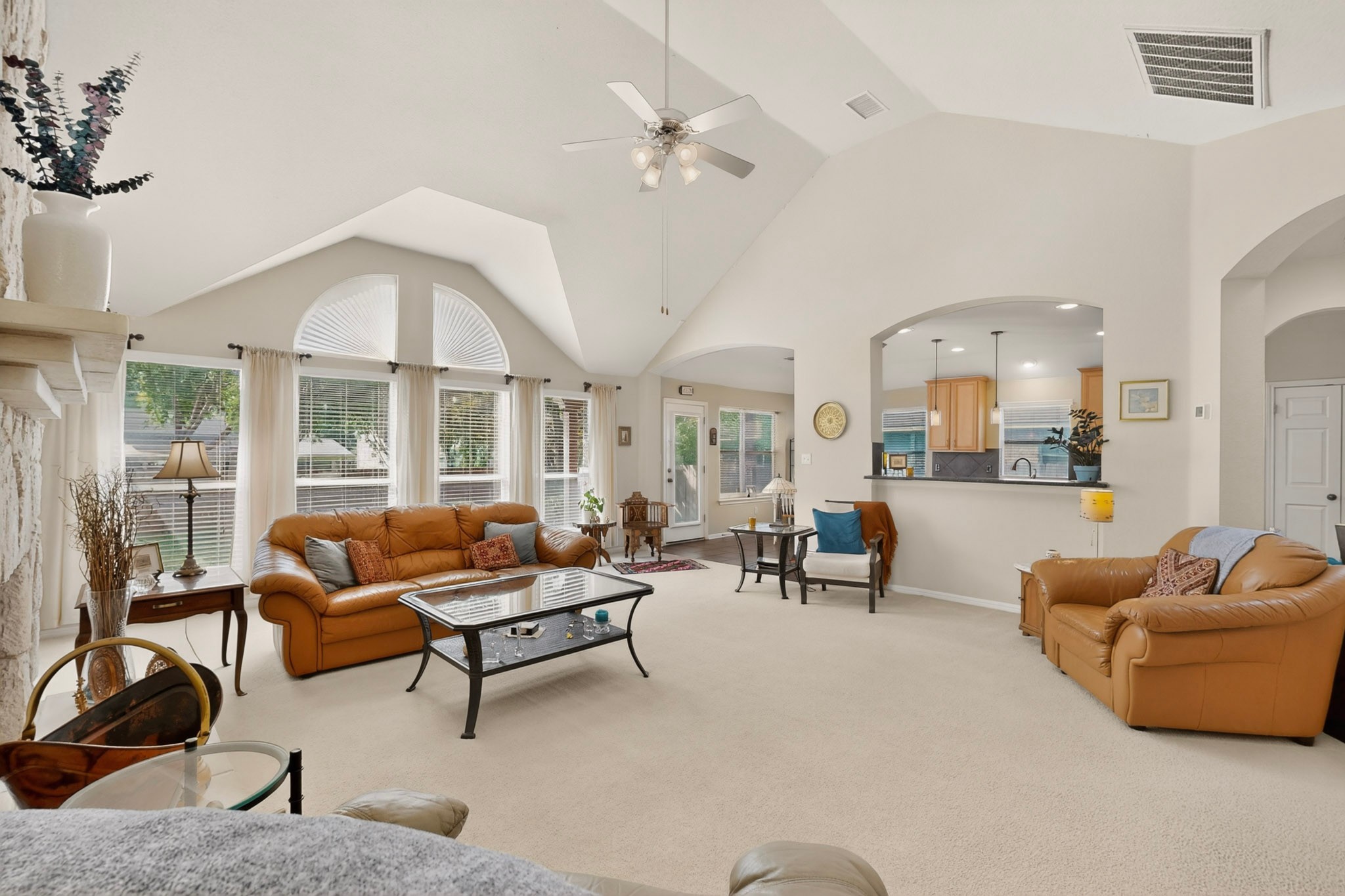 905 Victoria Ridge Drive Pflugerville, TX 78660 - Photo 1 of 32 A spacious living area with vaulted ceilings offers abundant natural light and an open view to the kitchen.