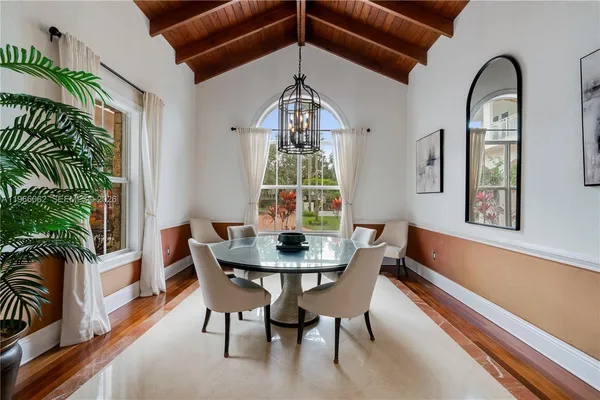 a large kitchen with kitchen island a large counter space a sink appliances and cabinets
