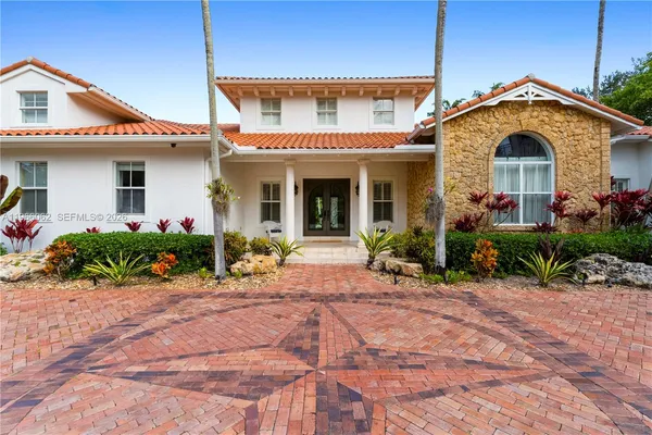 a front view of a house with garden