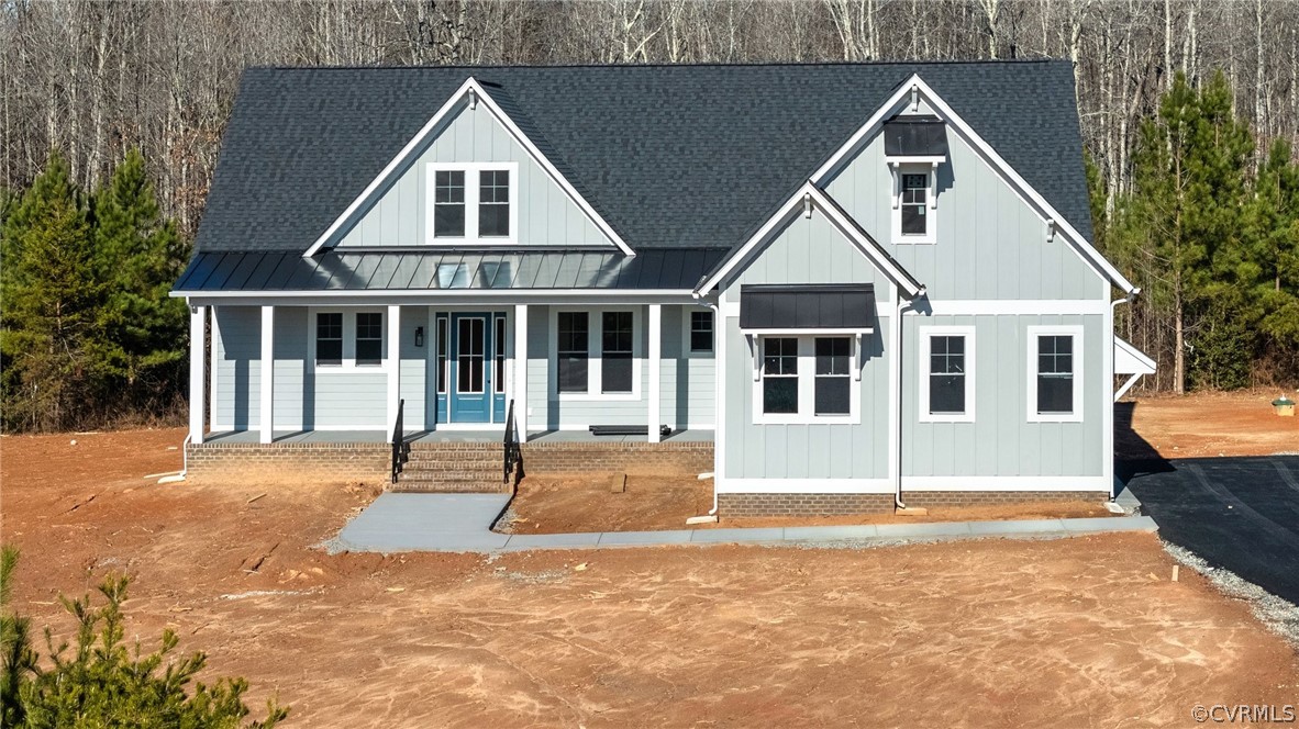 1558 Smokey Ridge Road Maidens, VA 23102 - Photo 34 of 43 a front view of a house with a yard and garage