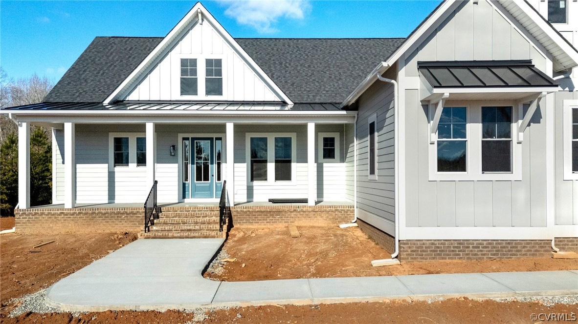 1558 Smokey Ridge Road Maidens, VA 23102 - Photo 41 of 43 a view of a white house with large windows and plants