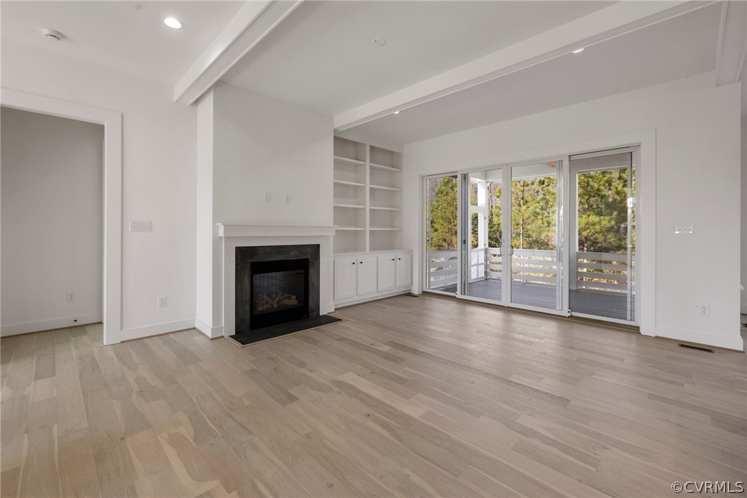 1558 Smokey Ridge Road Maidens, VA 23102 - Photo 7 of 43 a view of empty room with wooden floor and fireplace