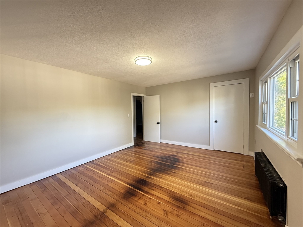 37 Bridge Street Monson, MA 01057 - Photo 13 of 35 a view of an empty room with wooden floor and a window