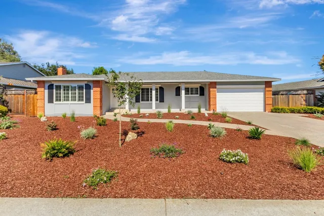 a front view of a house with garden