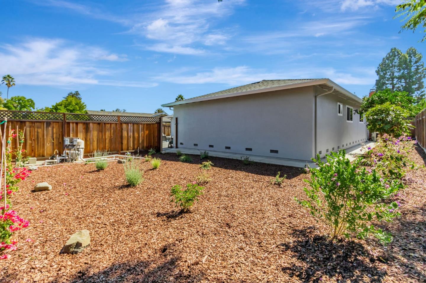 1051 Suffolk Way Los Altos, CA 94024 - Photo 47 of 47 a backyard of a house with lots of green space and wooden fence