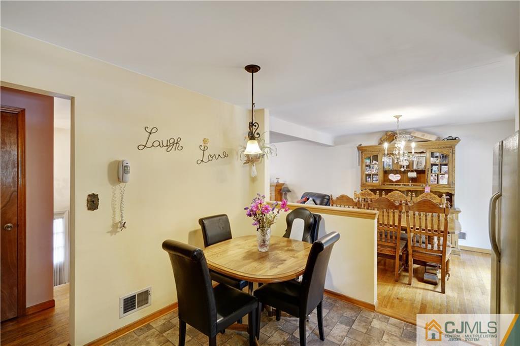 21 Louise Road Edison, NJ 08817 - Photo 11 of 29 a view of a dining room with furniture and wooden floor