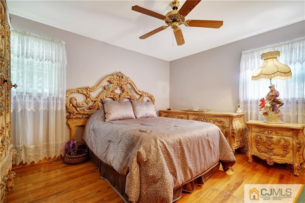 21 Louise Road Edison, NJ 08817 - Photo 12 of 29 a bedroom with a bed and a chandelier