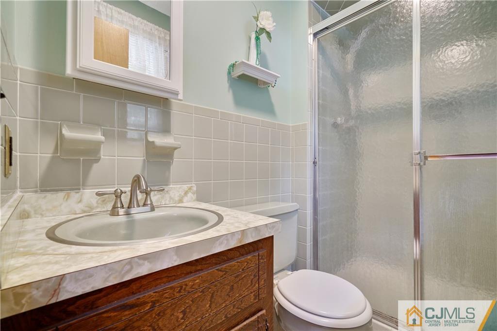 21 Louise Road Edison, NJ 08817 - Photo 14 of 29 a bathroom with a sink toilet and shower