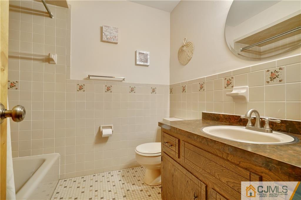 21 Louise Road Edison, NJ 08817 - Photo 19 of 29 a bathroom with a sink a toilet and shower