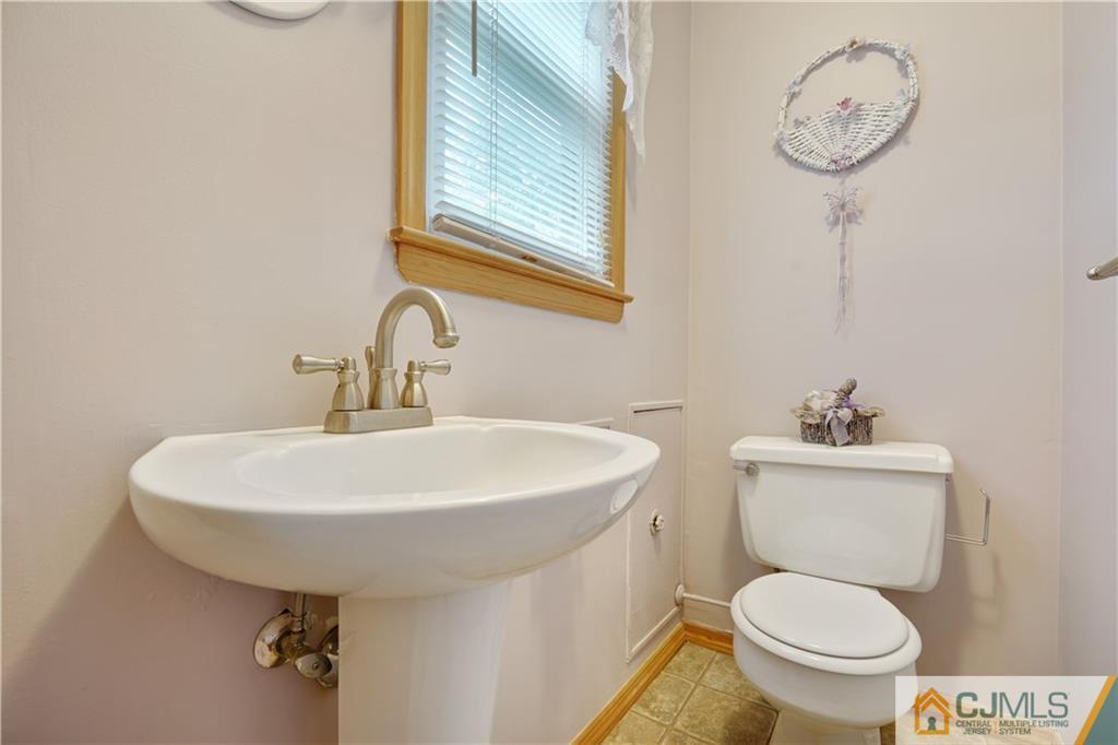 21 Louise Road Edison, NJ 08817 - Photo 24 of 29 a bathroom with a toilet a sink and mirror