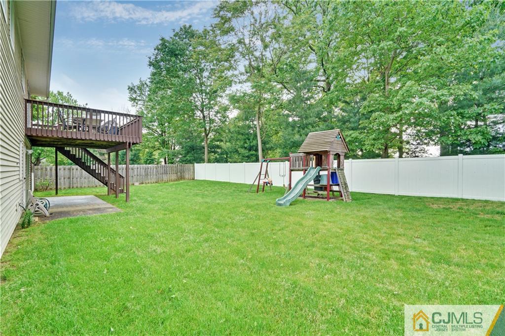 21 Louise Road Edison, NJ 08817 - Photo 26 of 29 a view of backyard with a slide and a bench