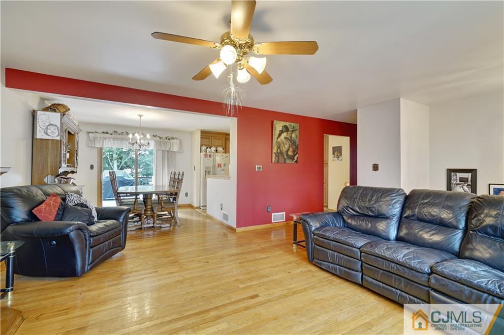 21 Louise Road Edison, NJ 08817 - Photo 5 of 29 a living room with furniture and a chandelier