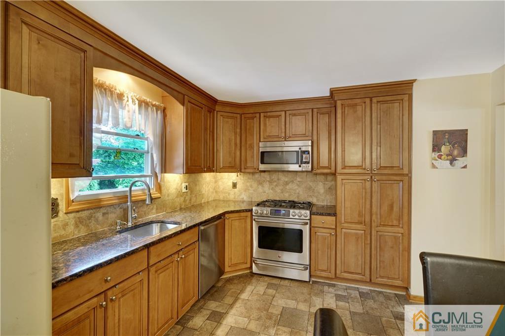 21 Louise Road Edison, NJ 08817 - Photo 9 of 29 a kitchen with stainless steel appliances granite countertop a stove a sink and a refrigerator