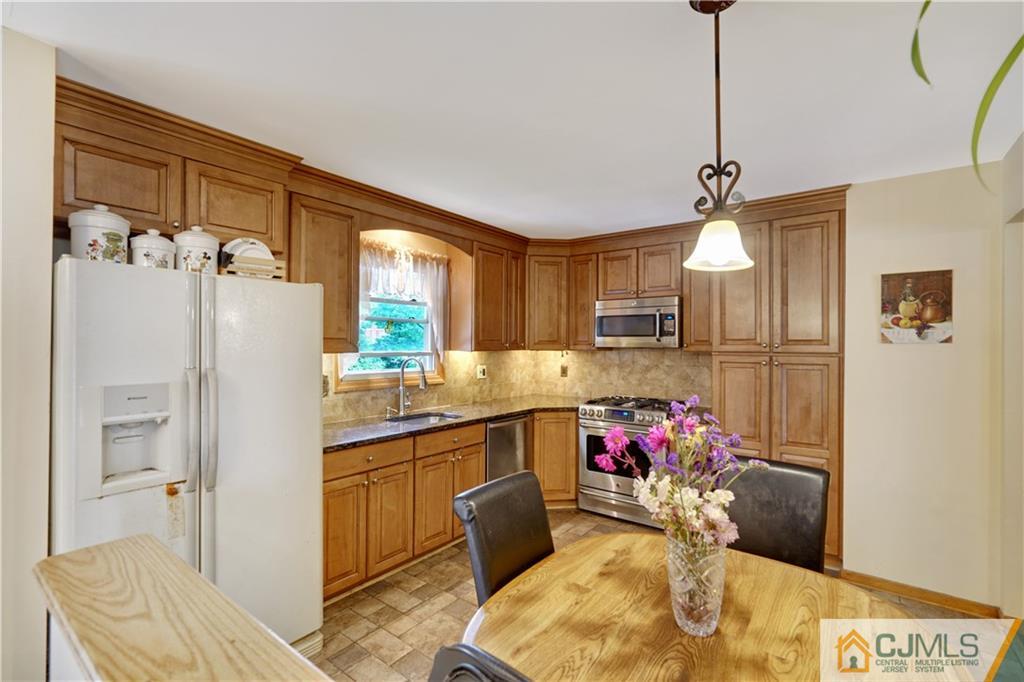 21 Louise Road Edison, NJ 08817 - Photo 10 of 29 a kitchen with a refrigerator and a sink