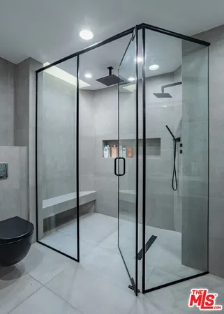 a bathroom with a glass shower door and a shower