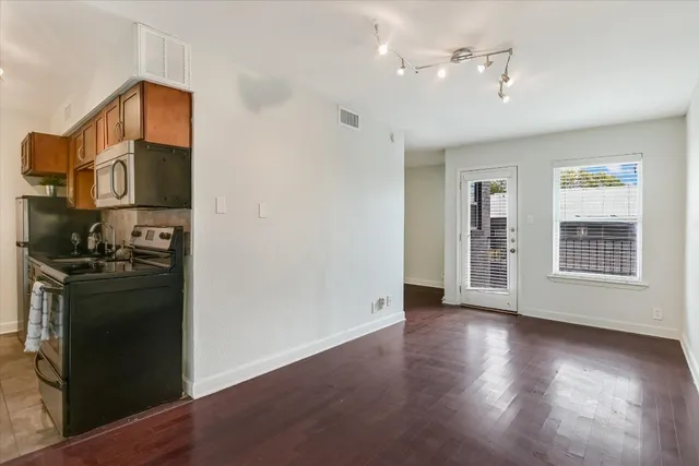 a view of a kitchen cabinets and wooden floor