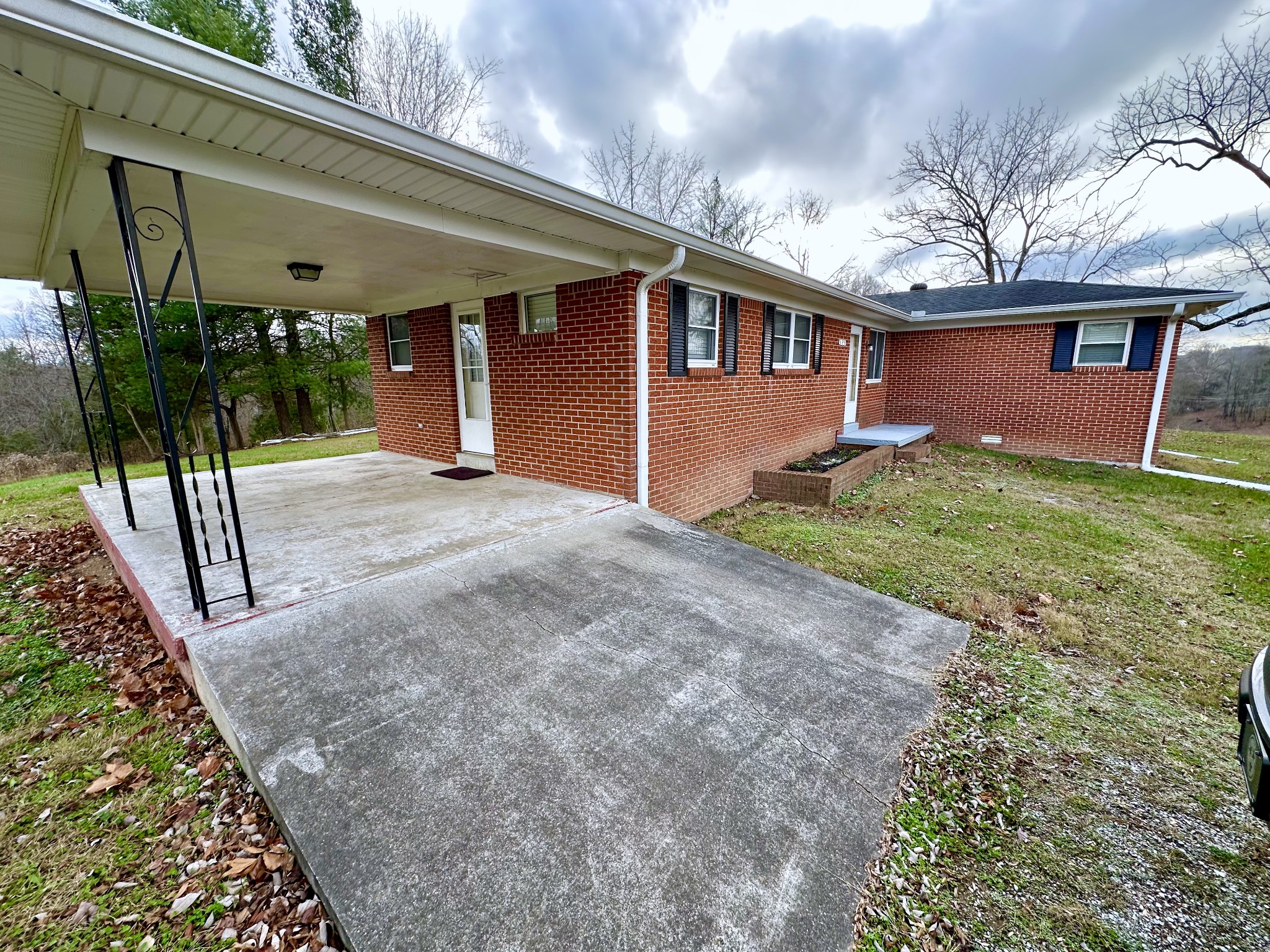 329 Poplar Drive Red Boiling Springs, TN 37150 - Photo 3 of 15 a view of a house with backyard and a tree