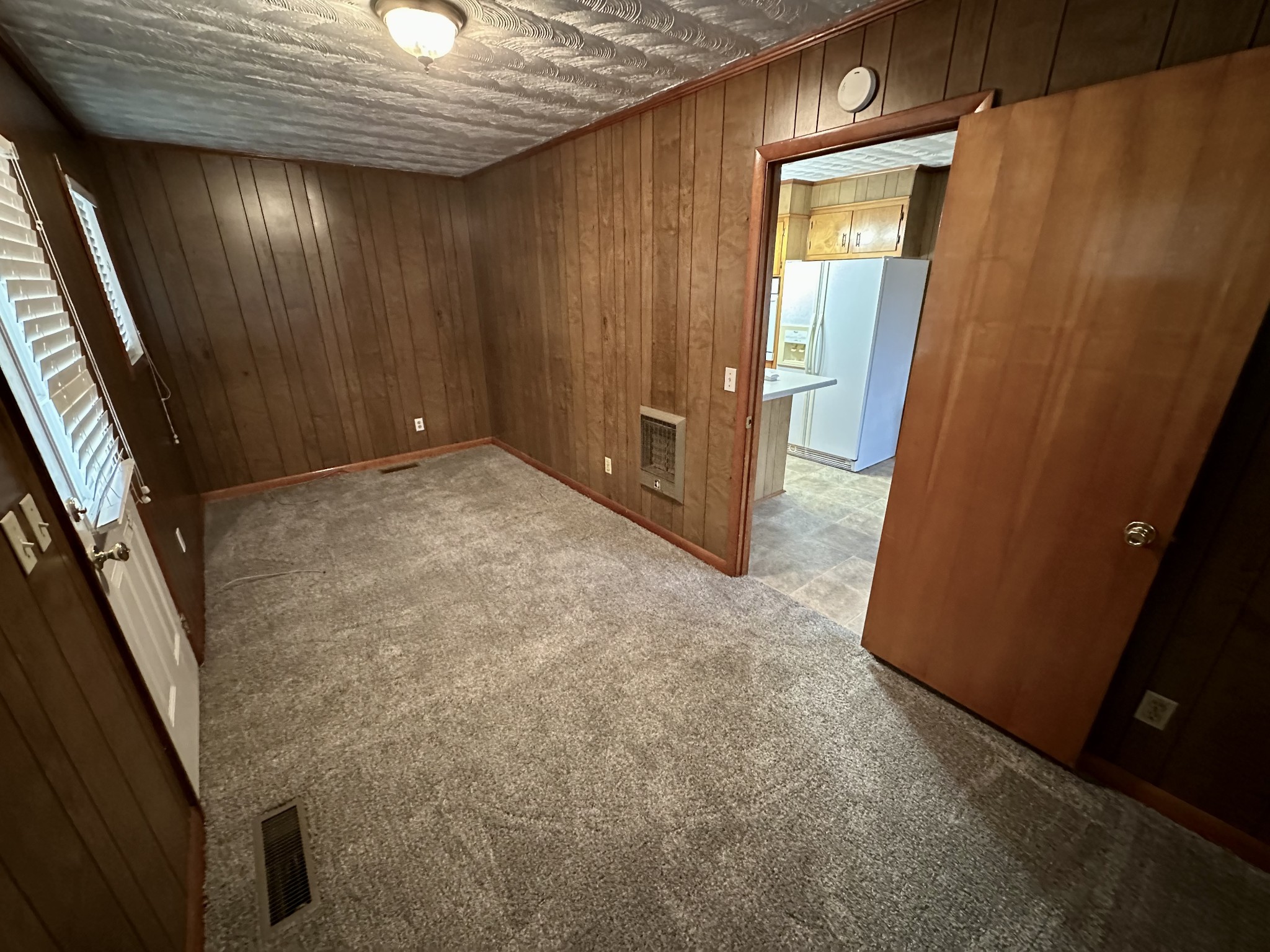329 Poplar Drive Red Boiling Springs, TN 37150 - Photo 4 of 15 an empty room with wooden floor and staircase