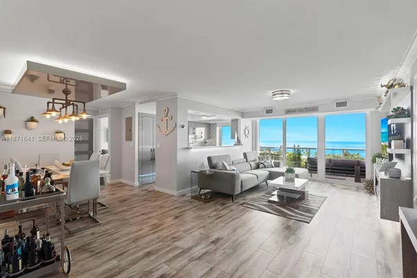 a living room with furniture hard wood floor and a flat screen tv