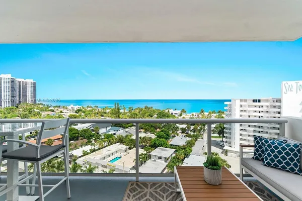 a view of a balcony with furniture