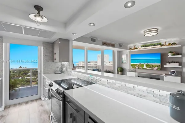 a kitchen with stainless steel appliances a stove a sink and a refrigerator